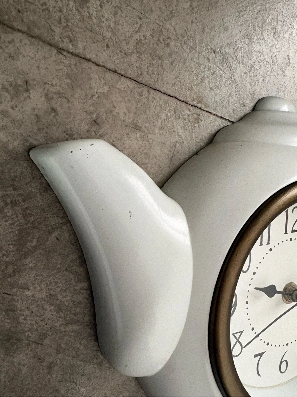 vintage teapot clock styled with a glossy white finish to look like ceramic.